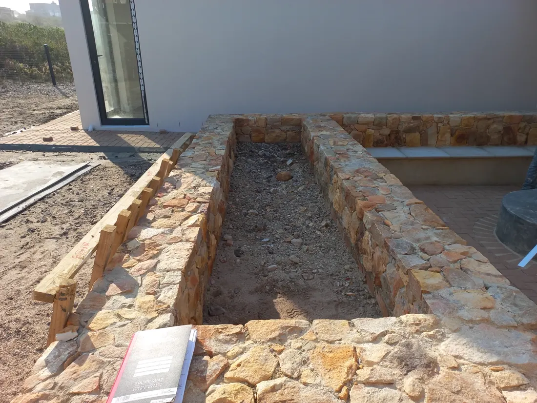 Before: Before and after of a stone raised garden bed